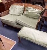 A 1920's mahogany framed three piece Bergere suite, together with a stool