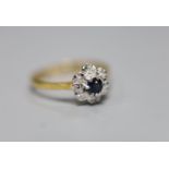 An 18ct, sapphire and illusion set diamond chip cluster ring, size L, gross 2.1 grams.