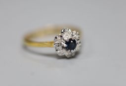 An 18ct, sapphire and illusion set diamond chip cluster ring, size L, gross 2.1 grams.