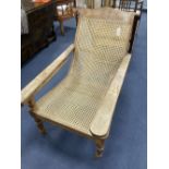 An early 20th century Anglo-Indian caned weathered plantation chair, width 66cm, depth 104cm, height