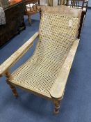 An early 20th century Anglo-Indian caned weathered plantation chair, width 66cm, depth 104cm, height