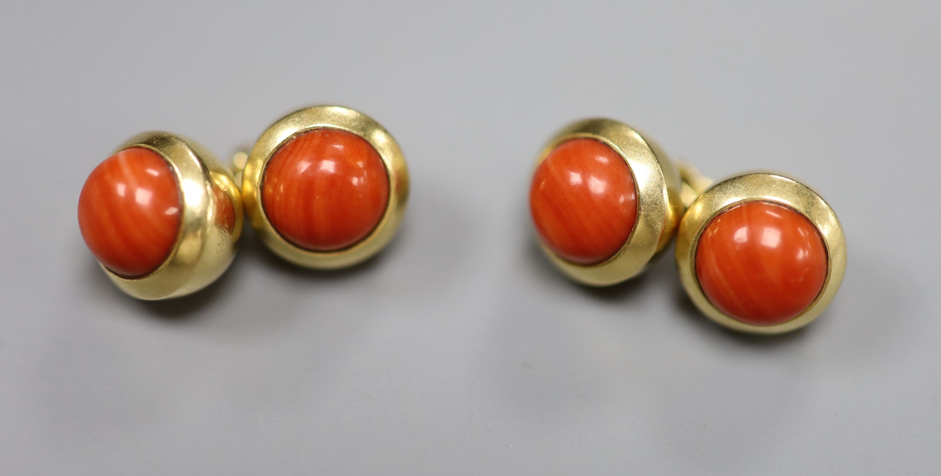 A pair of Cartier 750 yellow metal and coral bead set spherical cufflinks, signed and numbered