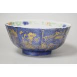 A Chinese Kangxi period porcelain bowl, the exterior glazed in powder blue with gilt tree and