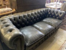 A Fleming & Howland, Chesterfields buttoned black leather three seater Chesterfield settee, length