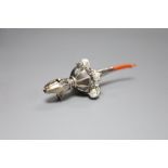 A George V silver child's rattle with coral teether and six bells, Crisford & Norris, Birmingham,