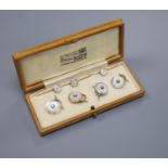 A cased set of four 1940's 18ct & Pt, mother of pearl and diamond set dress studs, gross 8.1 grams