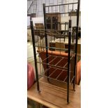 An early 20th century secessionist ebonised and tubular brass four tier newspaper stand, width 44cm,