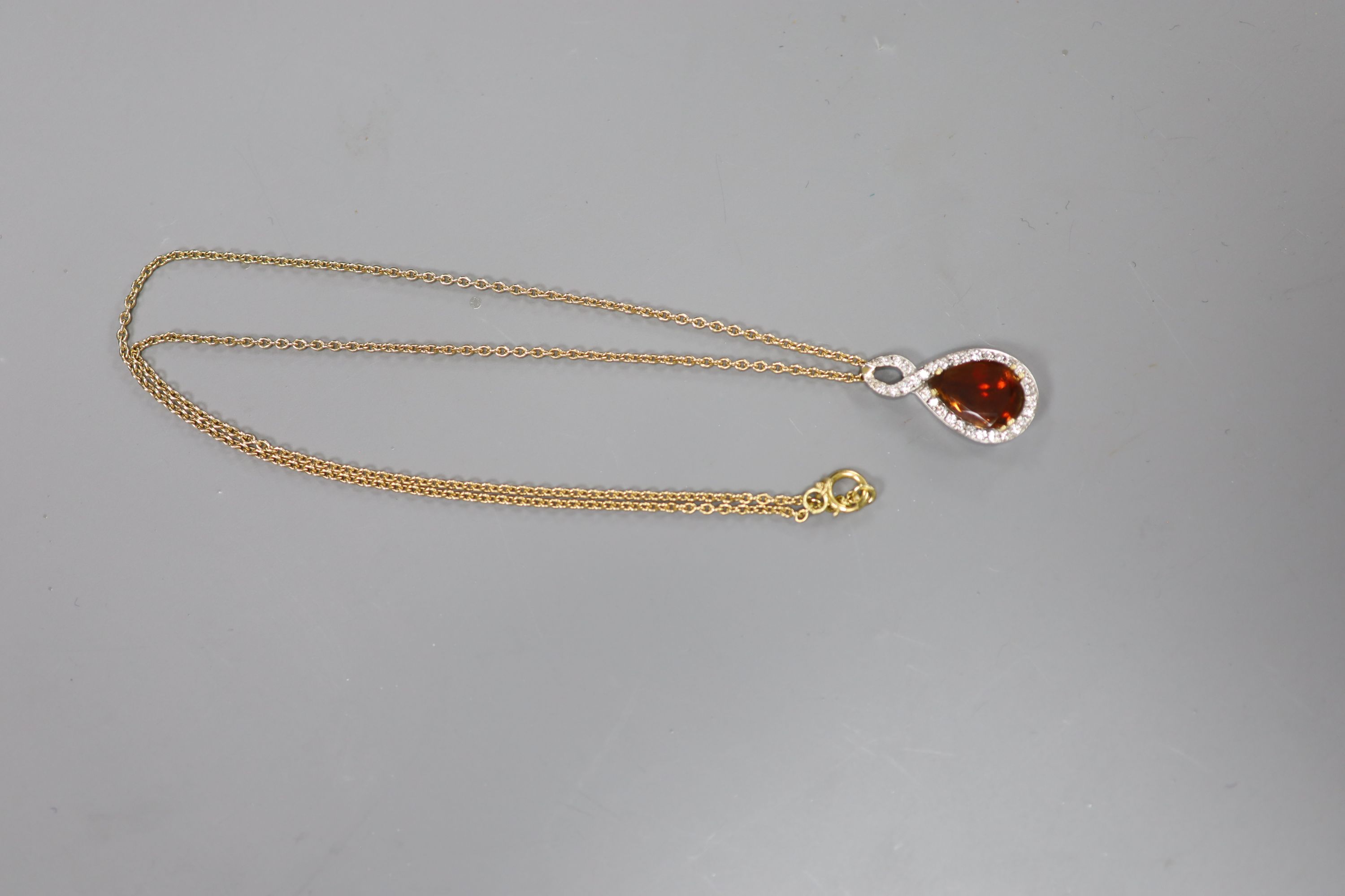 A white and yellow metal, garnet and diamond set teardrop shaped pendant necklace, pendant 29mm, - Image 3 of 4