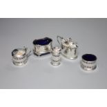 A George V small silver three piece condiment set, Birmingham, 1932 and two other silver