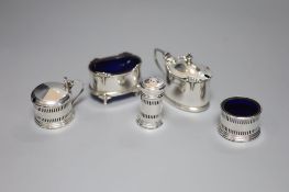 A George V small silver three piece condiment set, Birmingham, 1932 and two other silver