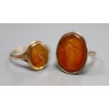 Two 19th century yellow metal and oval carnelian intaglio rings, carved with a bust or figure, one