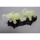 A carved bowenite jade group of two elephants, 16cm long with stand, boxed