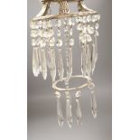 A plated ceiling light hung with clear glass drops