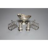 A small George III silver basket, London, 1785, a pair of Victorian silver peppers and a pair of