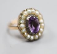 A 19th century, 9ct, amethyst and split pearl set oval cluster ring, size L, gross 5 grams.