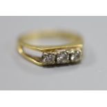 A modern 18ct gold and three stone diamond set ring, size K, gross 3.3 grams.