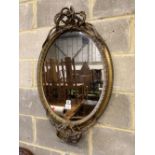 A Victorian giltwood and composition oval wall mirror, width 56cm, height 88cm