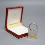 A steel and yellow metal Must de Cartier key fob, 52mm, with Cartier box.CONDITION: Numerous minor