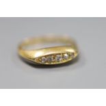 An 18ct gold and five stone diamond set half hoop ring, size J, gross 3 grams.