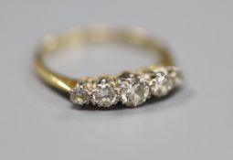 An 18ct and plat, graduated five stone diamond set half hoop ring, size N, gross 2.2 grams.