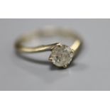 A modern 18ct gold set solitaire diamond ring, size S/T, gross 3.2 grams, the stone weighing