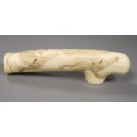 A Japanese Meiji period carved ivory cane handle