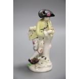An 18th century Bow figure of a piper with dog after a Meissen model by J.J. Kaendler, height
