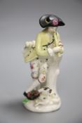 An 18th century Bow figure of a piper with dog after a Meissen model by J.J. Kaendler, height