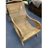 An early 20th century Anglo-Indian caned weathered teak armchair, width 57cm, depth 90cm, height