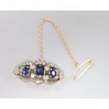 A Victorian synthetic?sapphire and diamond openwork bar brooch, silver setting, 27mm, gross 3.7g.