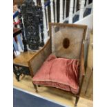 A Flemish carved oak dining chair and an Edwardian bergere chair