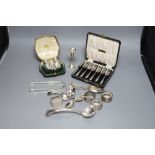 A cased set of six silver cake forks, four assorted silver napkin rings, minor silver flatware, a