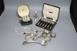 A cased set of six silver cake forks, four assorted silver napkin rings, minor silver flatware, a