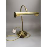 A copper overlaid fender, length 69cm, and a brass desk lamp