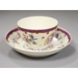 An 18th century Worcester teabowl and saucer painted Companie des Indes style with flowers in a