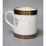 A 19th century Barr Worcester fine mug with a distinctive handle painted in under glaze blue and