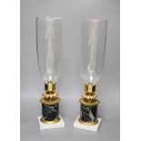 A pair of Regency style ormolu and marble candle lamps, height 48cm to glass storm