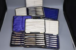 Seven assorted cased sets of silver handled tea knives including pistol handled.