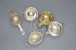 Five assorted 20th century silver tea strainers, 4oz.