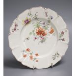An 18th century Derby shaped plate painted with flower in the manner of the Cotton Stem painter,