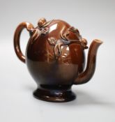 A small Brameld Cadogan teapot, relief moulded and gilded over a brown glaze, impressed mark, height