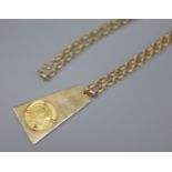 A 9ct gold ingot inset an 1894 sovereign, on 9K gold chain, gross 33g.