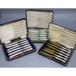 A cased set of six silver pistol handles tea knives(a.f.) and two other cased sets of knives.