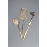 A continental pierced white metal cake slice and two other items including plated candle snuffer.