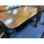 A George III style mahogany twin pedestal dining table, with two spare leaves, length 175cm, depth