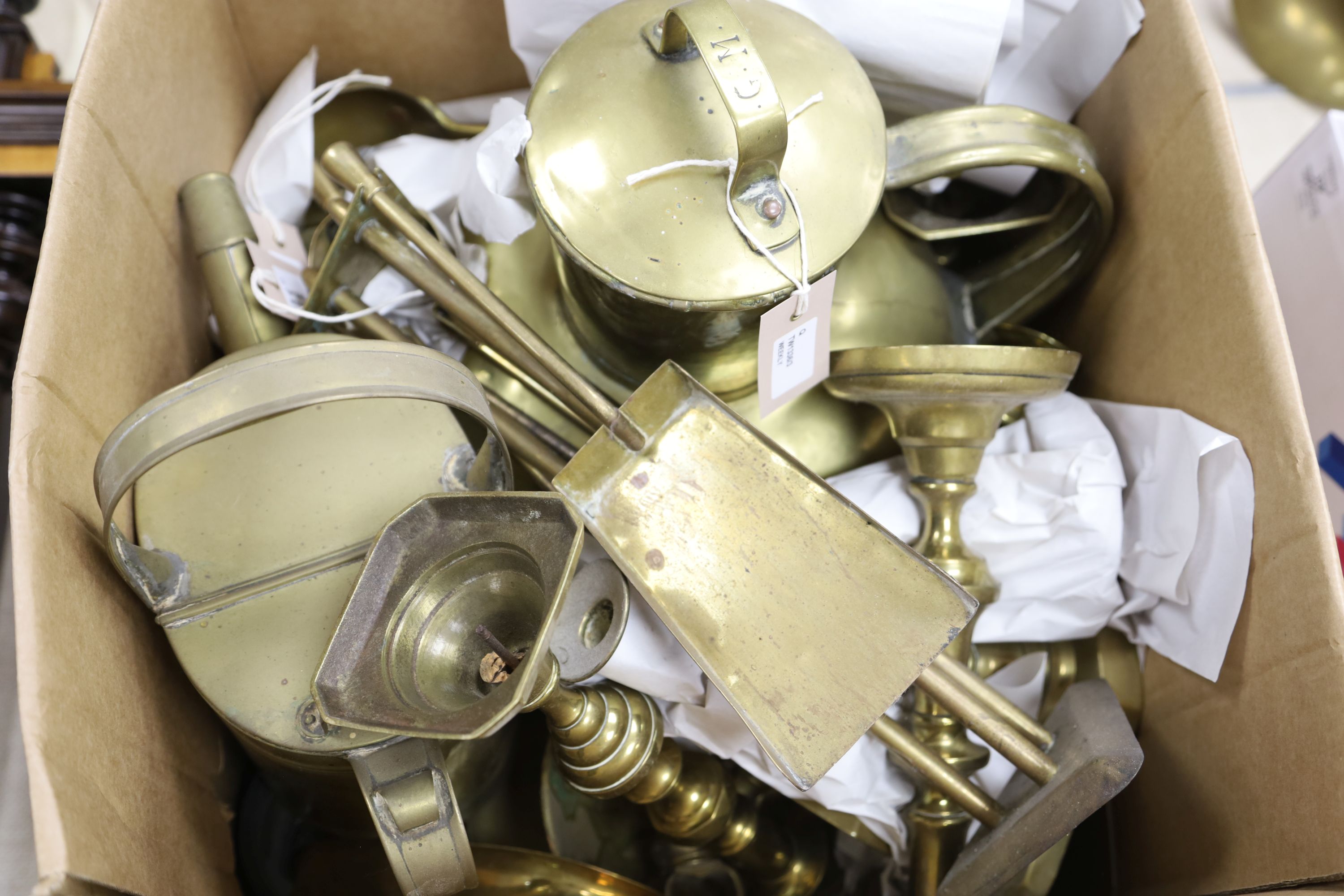 Collection of brass candlesticks, an Edwardian brass hot water jug, another brass jug and cover