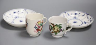 An 18th century Doccia cup with early scroll handle painted with flowers, another Doccia cup