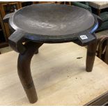 An African carved hardwood bowl seat three legged stool, diameter 60cm, height 52cm