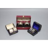 Three cased pairs of Edwardian and later silver napkin rings.