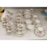 A Royal Albert 'Moss Rose' pattern tea service (41-pce) and a set of four Coalport botanical cups